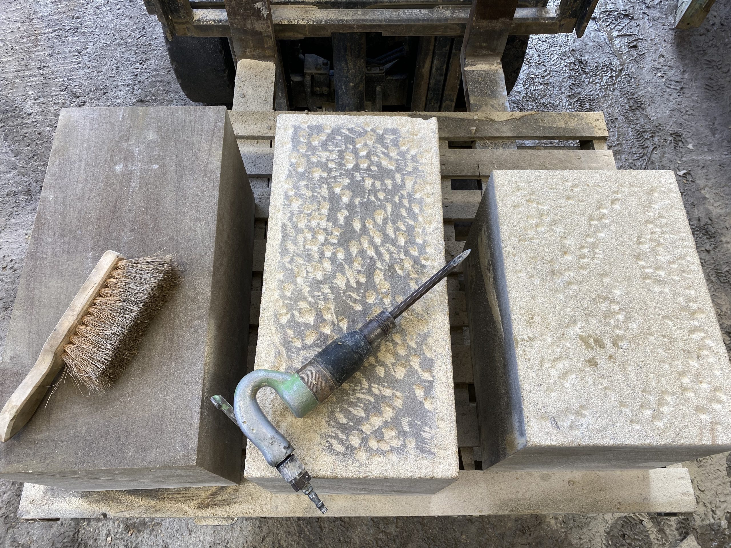 Masoning a block of new stone (left) into punched walling (right)